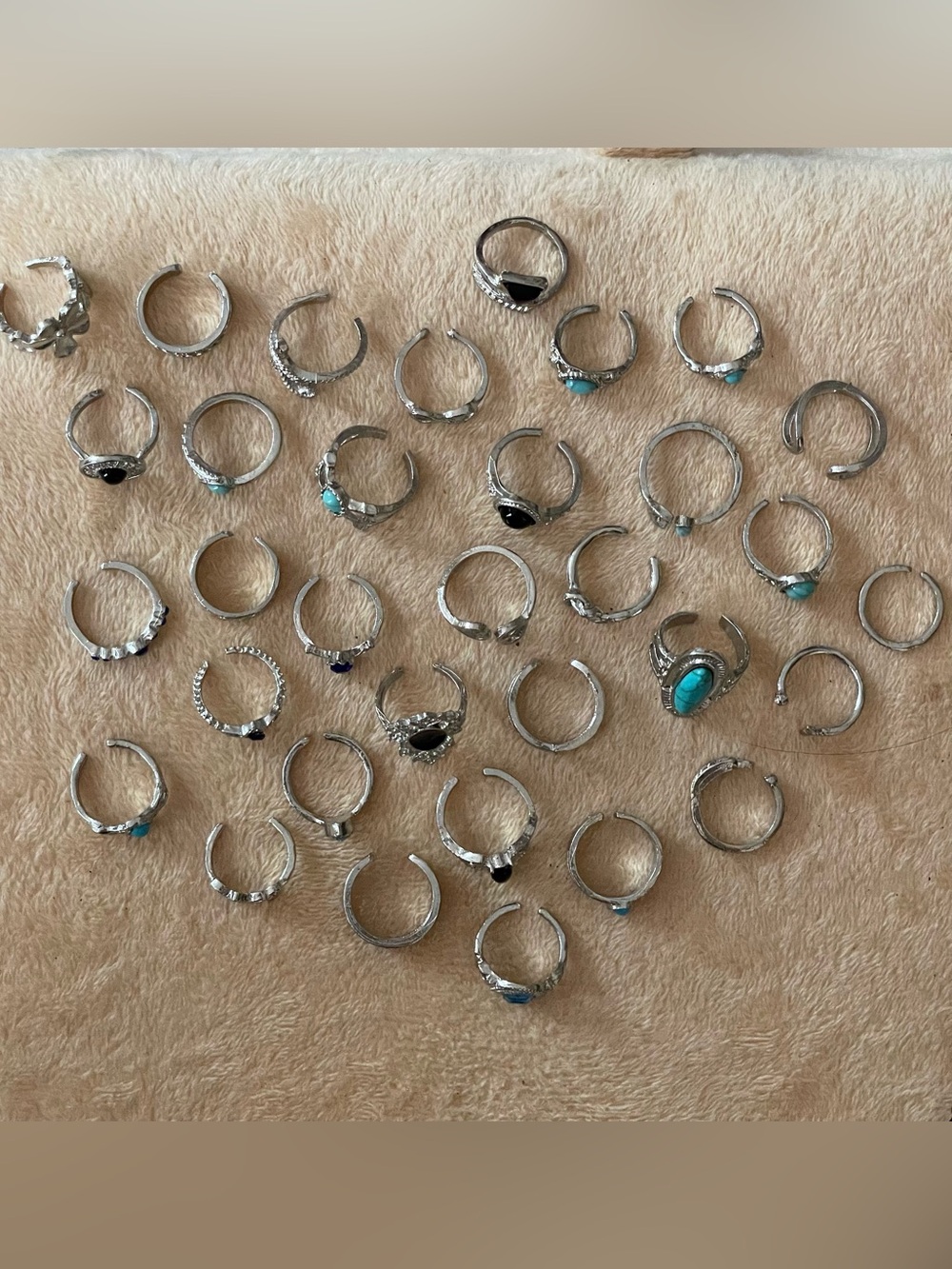 Lot of 33 silver tone toe-rings + extra black wire rings .